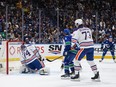 Edmonton Oilers goalie Stuart Skinner allows a goal to Vancouver Canucks' Elias Pettersson, back right, as Brock Boeser and Edmonton's Vincent Desharnais  watch during the first period in Game 2 of Stanley Cup second-round playoff series, in Vancouver May 10, 2024.