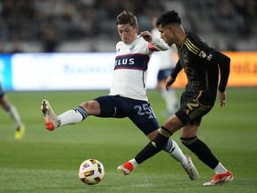 Vancouver Whitecaps midfielder Ryan Gauld  and Los Angeles FC defender Omar Campos  during the soccer match in Los Angeles May 11, 2024.