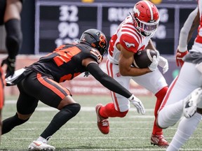 B.C. Lions defensive back Patrice Rene (24) tackles Calgary Stampeders wide receiver Reggie Begelton (84) during first half CFL preseason football action in Calgary, Saturday, May 25, 2024.