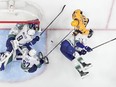 Vancouver Canucks goaltender Arturs Silovs (31), J.T. Miller (9), Ian Cole (82) and Tyler Myers (57) defend the goal against Nashville Predators' Ryan O'Reilly (90) during the third period in Game 6 of an NHL hockey Stanley Cup first-round playoff series Friday, May 3, 2024, in Nashville, Tenn.