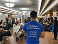 A volunteer provides language support at a job fair in Cornwall, Ont., on April 24.
