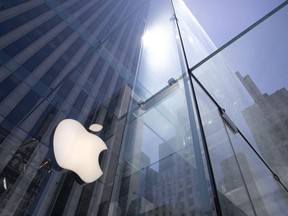 FILE - In this June 16, 2020 file photo, the sun is reflected on Apple's Fifth Avenue store in New York.