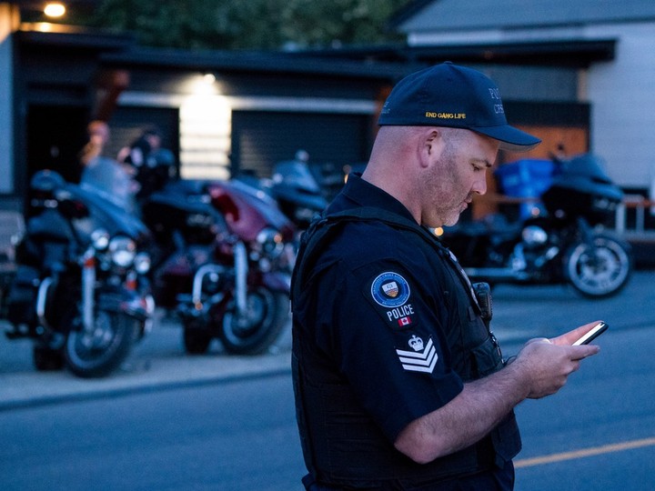  Sergeant Lindsey Houghton of The Combined Forces Special Enforcement Unit of British Columbia works from across the street of the Nanaimo Hells Angels clubhouse in 2018. Richard Lam/PNG
