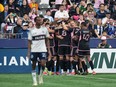 Inter Miami's Leonardo Campana (8) celebrates with his teammates after scoring as Vancouver Whitecaps' Ali Ahmed, front left, looks on during the second half of an MLS soccer match, in Vancouver, on Saturday, May 25, 2024.