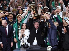 Majority owner Wyc Grousbeck of the Boston Celtics holds up the Larry O’Brien Championship Trophy after Boston's 106-88 win against the Dallas Mavericks in Game Five of the 2024 NBA Finals at TD Garden on June 17, 2024 in Boston.