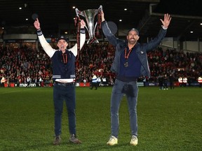 'I hope Ryan is going to be there, because he's promised to pick us all up from the airport in his uncle's minivan,' said Wrexham executive director Humphrey Ker. Wrexham AFC, which is co-owned by Ryan Reynolds and Rob McElhenney (pictured), will play the Vancouver Whitecaps on July 27.
