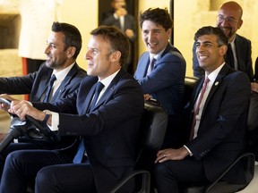 French President Emmanuel Macron driving a golf car with British Prime Minister Rishi Sunak, President of the European Council Charles Michel and Canadian Prime Minister Justin Trudeau, during the welcome dinner at the Swabian Castle of Brindisi as part of the G7 summit on June 13, 2024. (Photo by HANDOUT/Quirinale Press Office/AFP via Getty Images)
