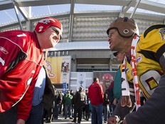 Hamilton Tiger-Cats fan Jason Offiong, right, and Calgary Stampeders fan Troy Patterson face off for a photo before the 102nd Grey Cup at BC Place in 2014. It was the last time Vancouver hosted the Grey Cup and festival, and expect this year's event to be at least triple the size.
