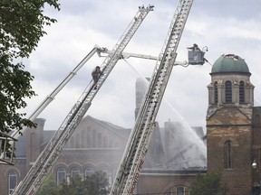 Firefighters work to put out a blaze at St. Anne's Anglican Church in Toronto's west end on Sunday, June 9, 2024.