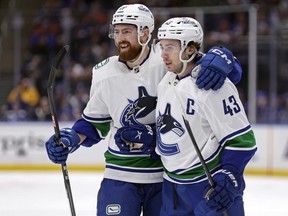 Vancouver Canucks defenceman Quinn Hughes is congratulated by Filip Hronek for a goal against the New York Islanders during the first period of an NHL hockey game Jan. 9, 2024, in Elmont, N.Y.