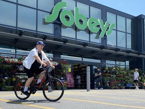 Grocery company Empire Co. Ltd. reported its fourth-quarter profit fell compared with a year ago, but raised its quarterly dividend. Shoppers are seen at a west-end Toronto Sobeys grocery store on Sunday, June 26, 2023.