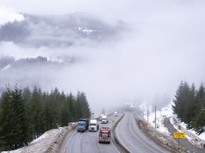 Vehicles are seen as they drive along the Coquihalla Highway Wednesday, January 19, 2022. Environment Canada is warning motorists of possible snow at mountain passes on a number of major highways across British Columbia's Interior.