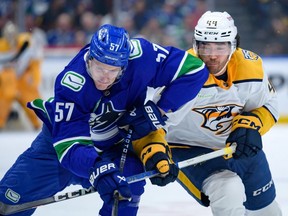 Kiefer Sherwood of the Predators checks Tyler Myers of the Canucks during Game 1 of the first-round NHL playoff series on April 21 at Rogers Arena.