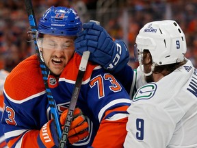 Oilers defenceman Vincent Desharnais absorbs hard hit from new Canucks teammate J.T. Miller during Game 4 of a first-round playoff series May 14 in Edmonton.