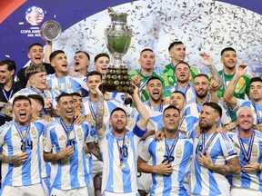 Argentina's forward #10 Lionel Messi lifts up the trophy as he celebrates winning the Conmebol 2024 Copa America tournament final football match between Argentina and Colombia at the Hard Rock Stadium, in Miami, Florida on July 14, 2024. (Photo by CHARLY TRIBALLEAU / AFP)