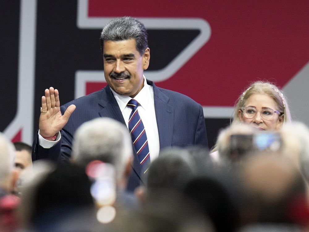 Venezuelan President Nicolas Maduro arrives with his wife Cilia Flores for a ceremony to declare that he won the country's disputed presidential election, in Caracas, Venezuela, Monday, July 29, 2024.