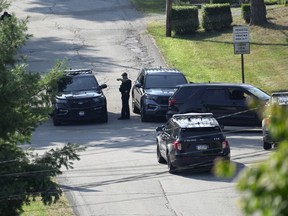 Law enforcement block a street in Bethel Park, Pa., that they say had a residence of Thomas Matthew Crooks, the suspected shooter of former President Donald Trump, Sunday, July 14, 2024.