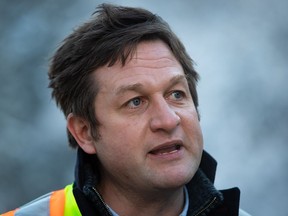 British Columbia Transportation Minister Rob Fleming speaks after meeting workers responsible for helping get the Coquihalla Highway reopened to commercial traffic northeast of Hope, B.C., on December 20, 2021.