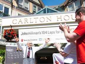 Second World War veteran John Hillman, shown in a handout photo, raises his hands in triumph after completing 104 laps of his Victoria retirement home as part of an annual fundraising walk for Save the Children, one lap for each year of his life. Hillman died Monday at the age of 105.