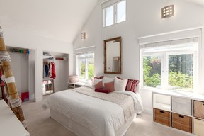 The light-filled primary bedroom on the top floor has vaulted ceilings and an ensuite bathroom.