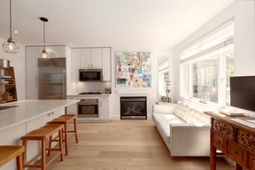An open-concept living space on the main floor contains the kitchen, living and dining areas.