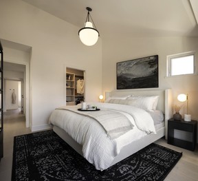 The primary bedroom features an ensuite bathroom, one of the design highlights in the home.