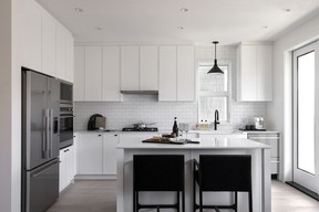 The kitchen features a subway tile backsplash and quartz countertops.