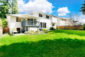 manicured gardens in back of detached 1989 house