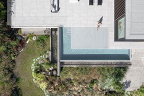 A stream feature flows around and under the house, complemented by natural-looking rockwork.