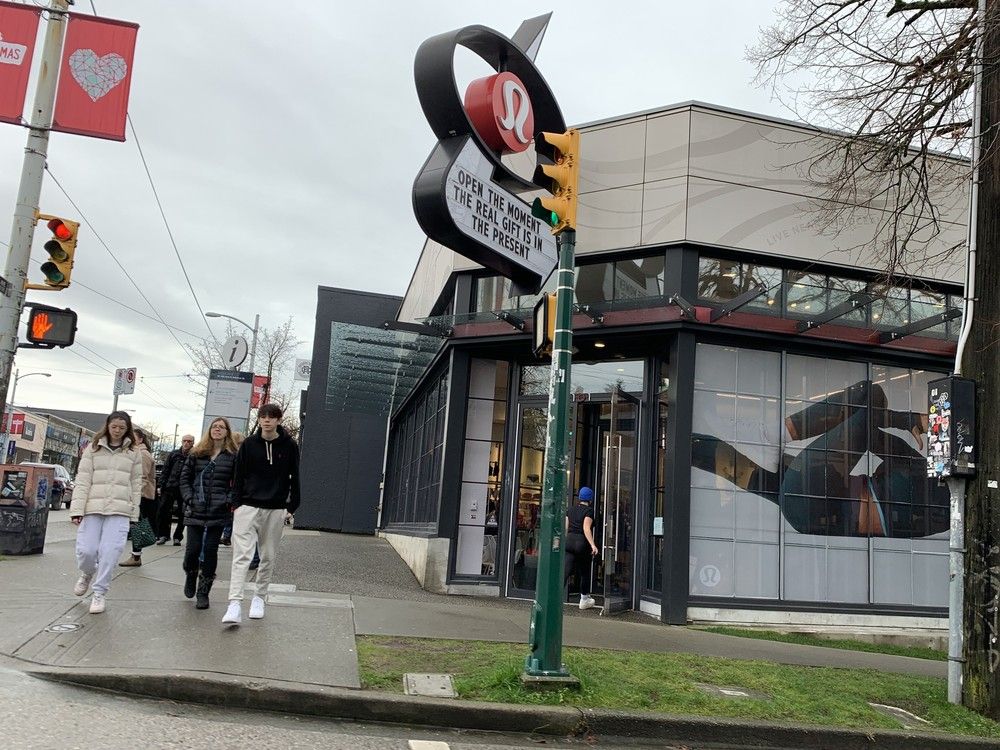  shoppers walk along west 4th in vancouver past the lululemon store on boxing day 2024