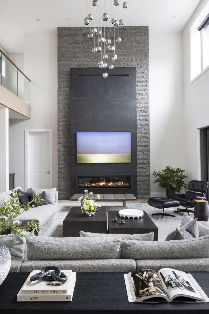  A two-storey stone-and-steel fireplace anchor the great room, which is subtly layered with texture and tones to make the large space feel homey.