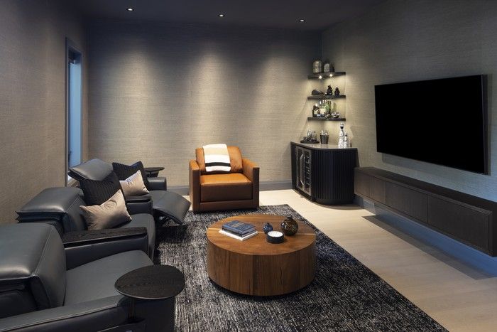  A golf simulator and comfy home theatre make the rec room a perfect spot to relax.