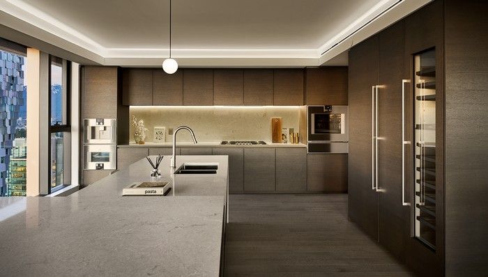  The minimalist sub-penthouse kitchen features integrated Gaggenau appliances with sleek cabinetry by award-winning Italian brand Minotti Cucine.