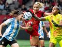 Argentina's Aldana Cometti, Canada's Adriana Leon, centre, and Argentina goalkeeper Solana Pereyra during the first half of an international friendly soccer match in Vancouver, on Friday, April 4, 2025.