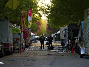 Members of the Vancouver Police forensics team examine the scene where a vehicle drove into a crowd at a Lapu Lapu Day street festival Saturday evening in Vancouver, Sunday, April 27, 2025.