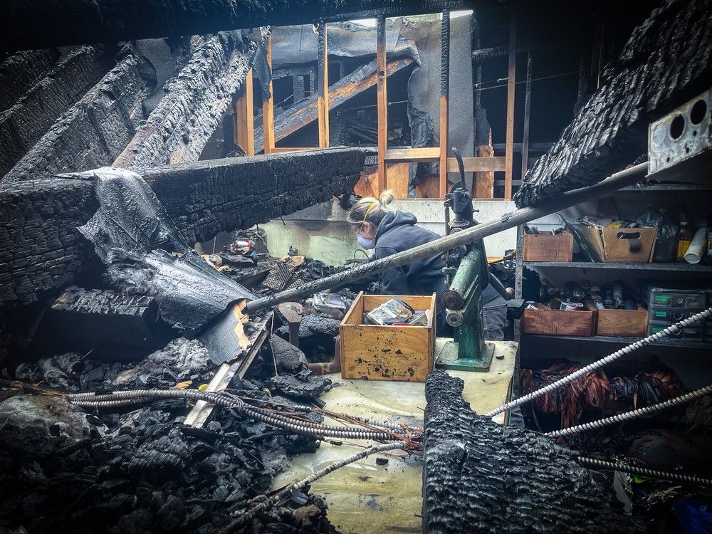 Handout photograph of shoemaker Amy Slosky visiting her studio on May 7 sorting through debris after an April 23 fire. Handout photograph of shoemaker Amy Slosky visiting her studio on May 7 sorting through debris after an April 23 fire.