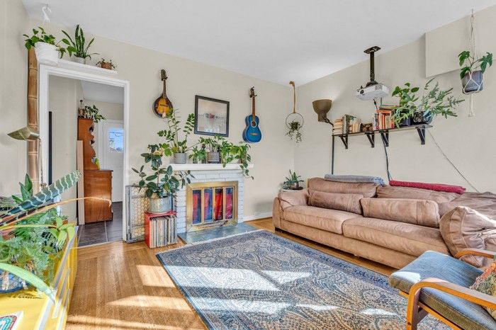  Home features oak hardwood floors and a brick-surround wood-burning fireplace.