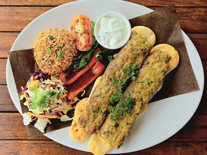 BBQ Chicken Kebabs with Naan Bites, Tomato Rice and Tzatziki. Recipe by: Bae Side corporate Chef Sumit Chauhan. Handout/ (single use)