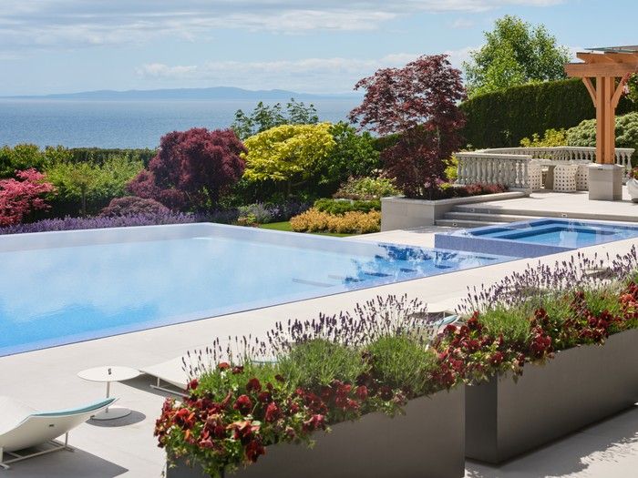 Meticulously shaped garden beds feature densely planted lavender, maples, fruit trees and other shrubs.