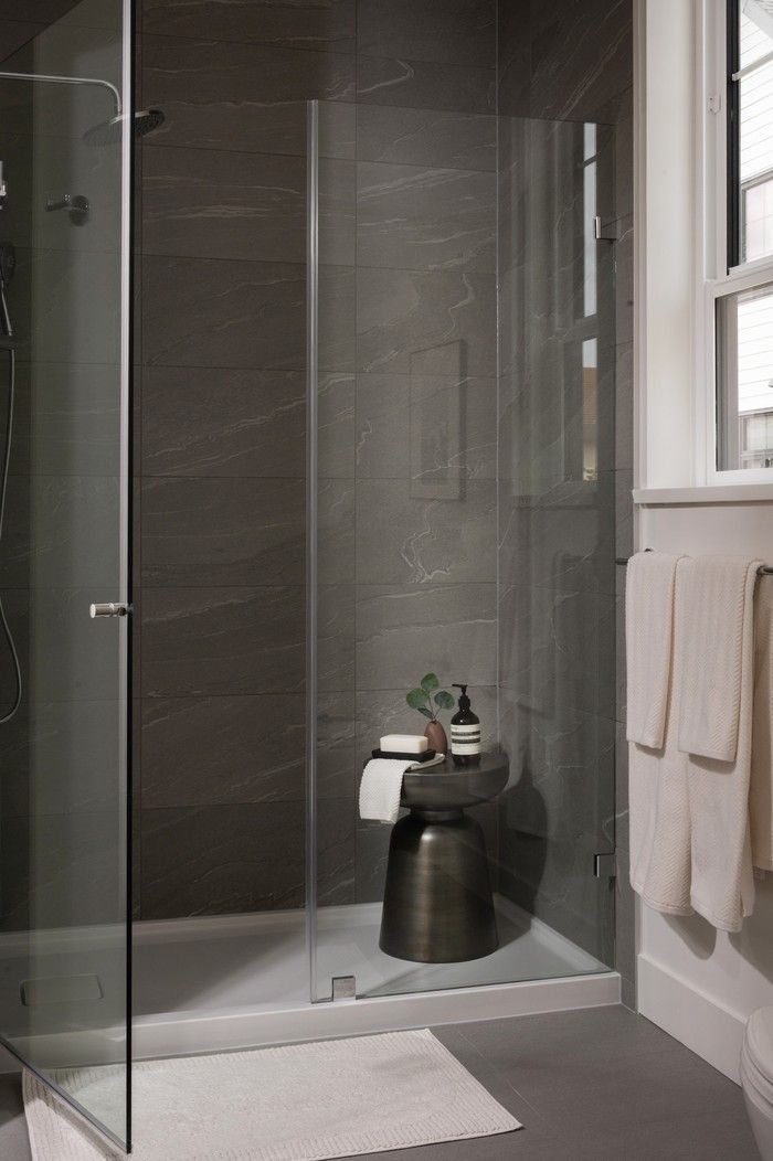  The shower blends form and function with a bench and a built-in niche for essentials.