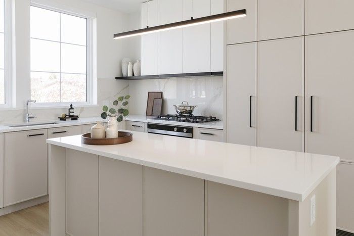  The bright, airy kitchen balances esthetics with functionality, with a generous amount of storage, open shelving and modern Shaker cabinetry.