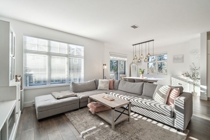  Living and dining area has contemporary-style lighting and access to a rear deck.