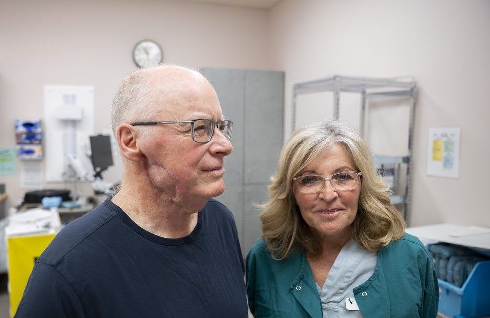  malcolm matheson, left, a patient of the facial esthetic medical tattoo program at eagle ridge hospital, with sandi saunier, the surgical nurse who performed the medical tattoo.