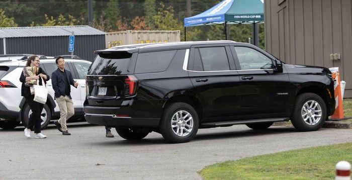  Mayor Ken Sim returns to his police vehicle after an event in Vancouver on Friday.
