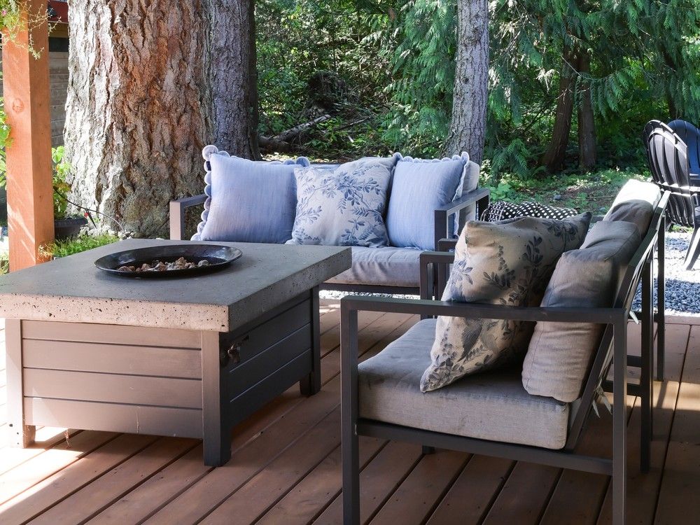  The home’s covered back patio is a forest-fringed retreat usable most of the year – perfect for a family that loves the outdoors and wanted a seamless connection between indoor and outdoor living. Arnhildur Aluminum Outdoor Lounge Chairs by Latitude Run offer comfy seating.