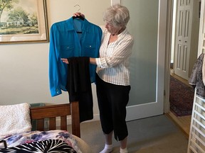Gail Lane in her Victoria home picking out clothes. Photo courtesy Gail Lane. Photo by Providence Health Care