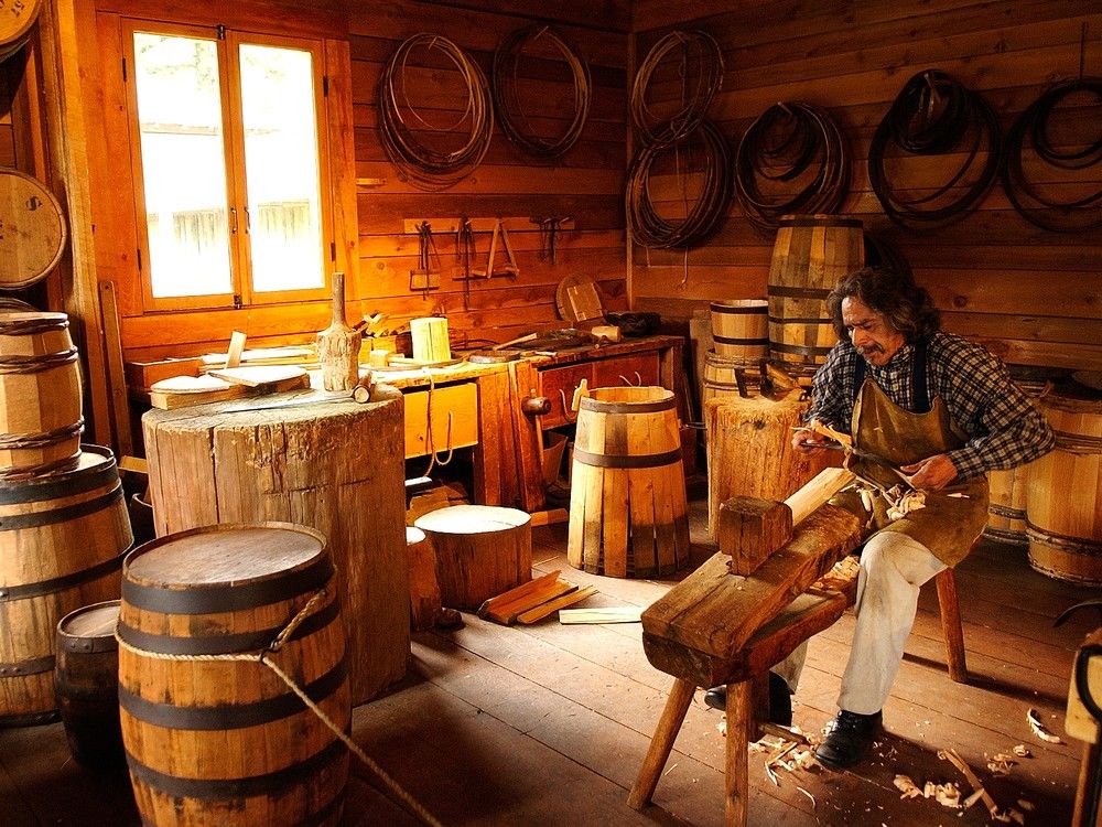  using a drawknife to make a stave for a wooden bucket at the fort langley national historic site.