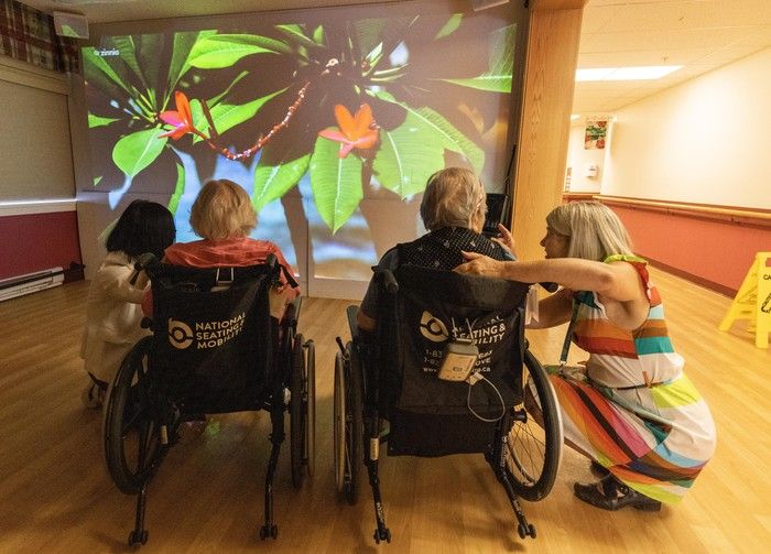 seniors watch tv at rosewood manor