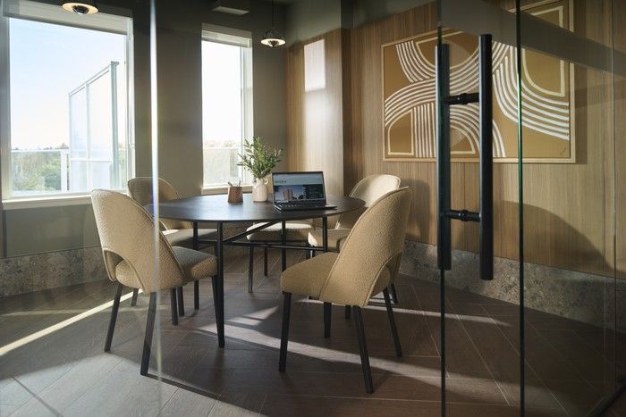  The co-working lounge is a quiet, comfortable space that features meeting rooms that open up to the outdoor patio.