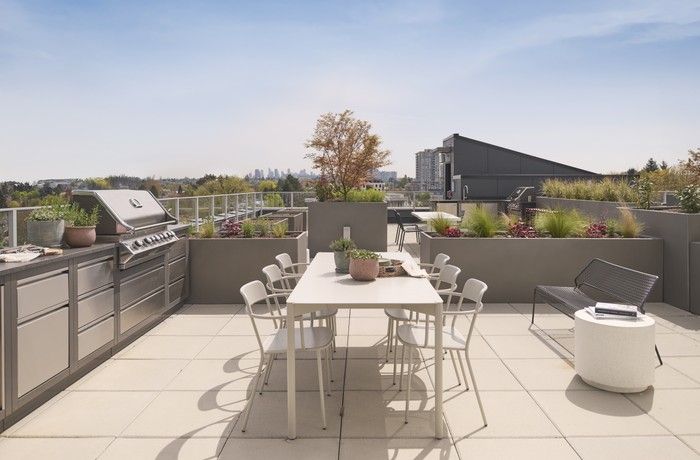  The shared terrace has unobstructed views of the cityscape and mountain range, and includes several garden plots and grills.